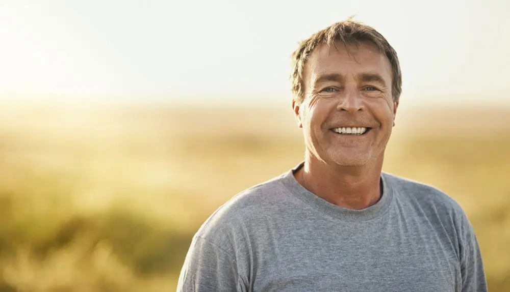 Test Dental Implants 1 Smiling man in a field.