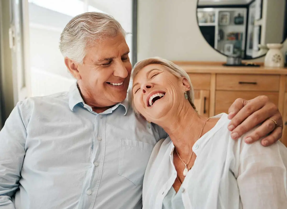 Test Homepage New 2 Happy senior couple embracing and laughing.
