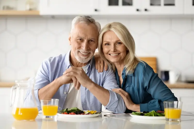 Dental Implants Homer Glen 47 Happy senior couple enjoying healthy meal.