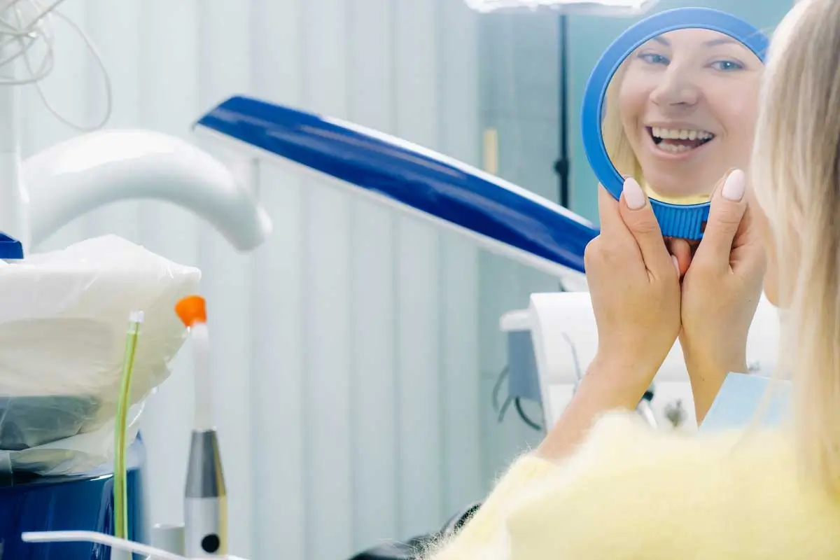 Woman admiring her post-treatment smile.