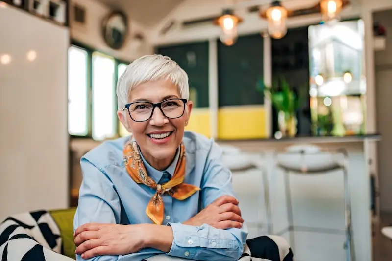 Smiling woman with short gray hair.